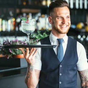 A barman wearing hospitality workwear
