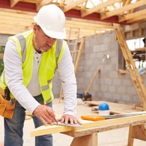 A carpenter wearing high vis vest workwear